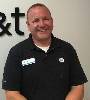 Tedd smiling with the AT&T logo behind him