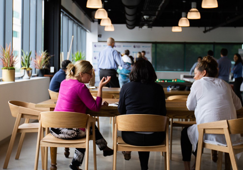 people sitting in chairs at an office