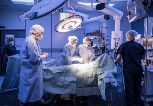 Surgeons and health care professionals in an operating theatre
