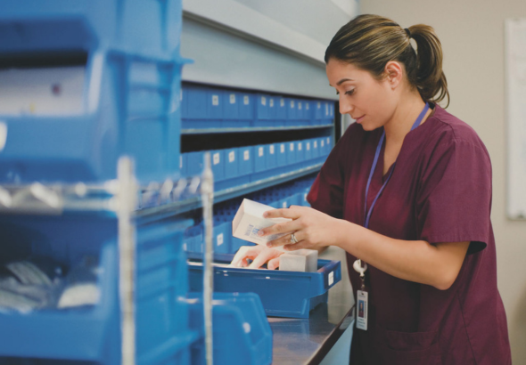 Nurse taking medication out of a drawer