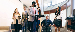 A group of employees talking in a corridor