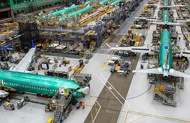 massive warehouse filled with Boeing airplanes and parts