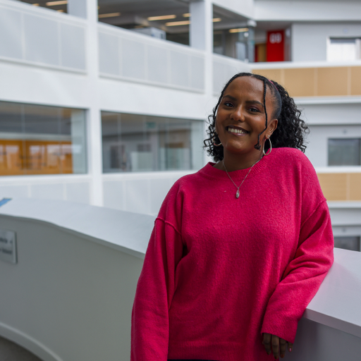 Smiling woman leaning against a balcony at the Co-op head office