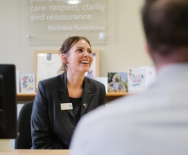 Woman in uniform smiling during a meeting