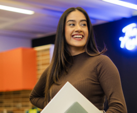 Smiling woman standing with Laptop