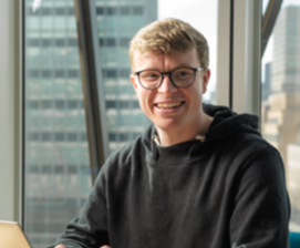 Man smiling in front of laptop