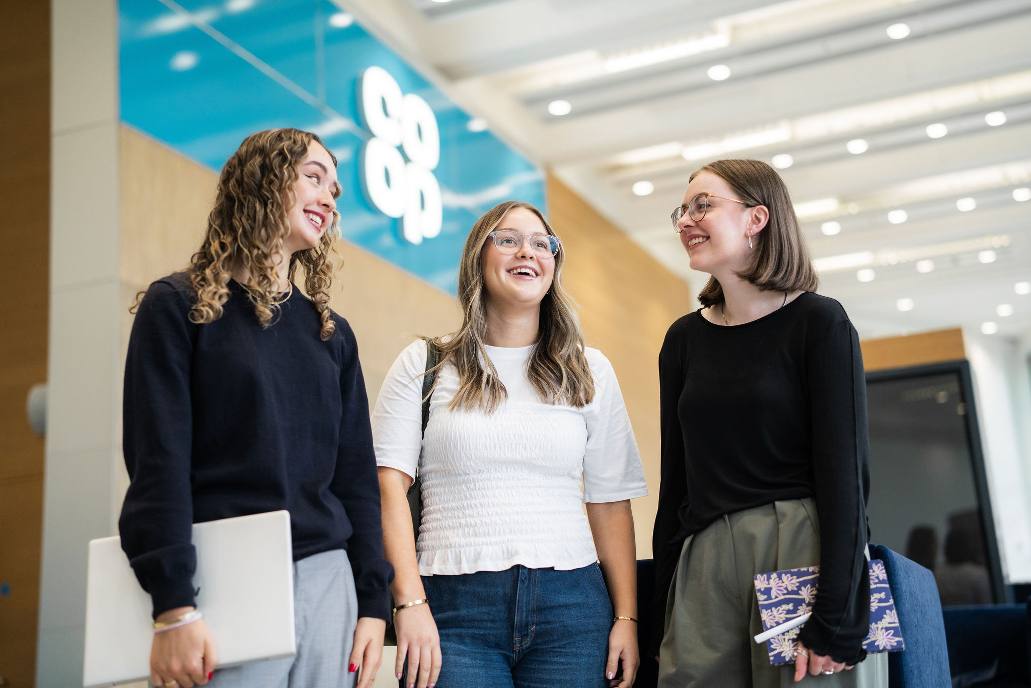 3 women standing and talking