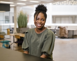 Smiling woman sitting in modern office space