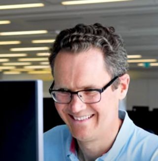 man smiling at computer