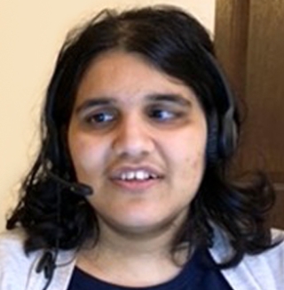 Blind woman smiling while wearing a headset.