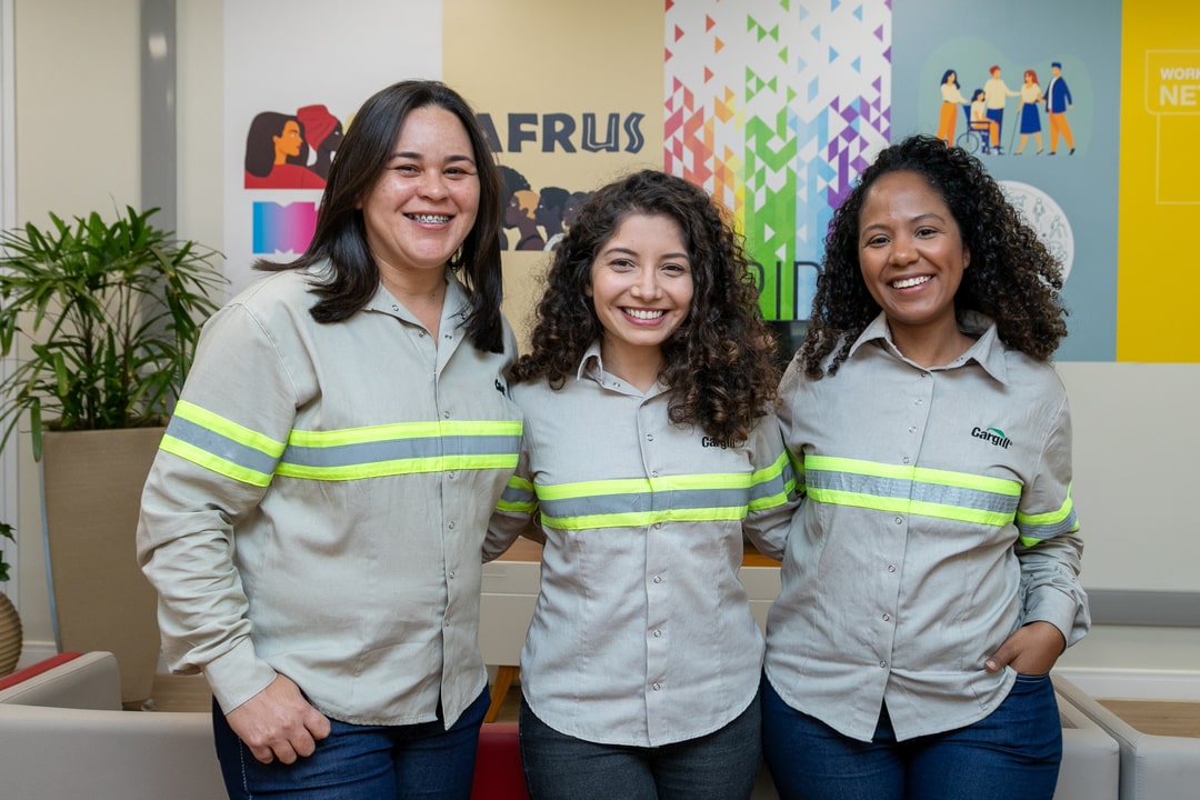 Three women laughing in an office