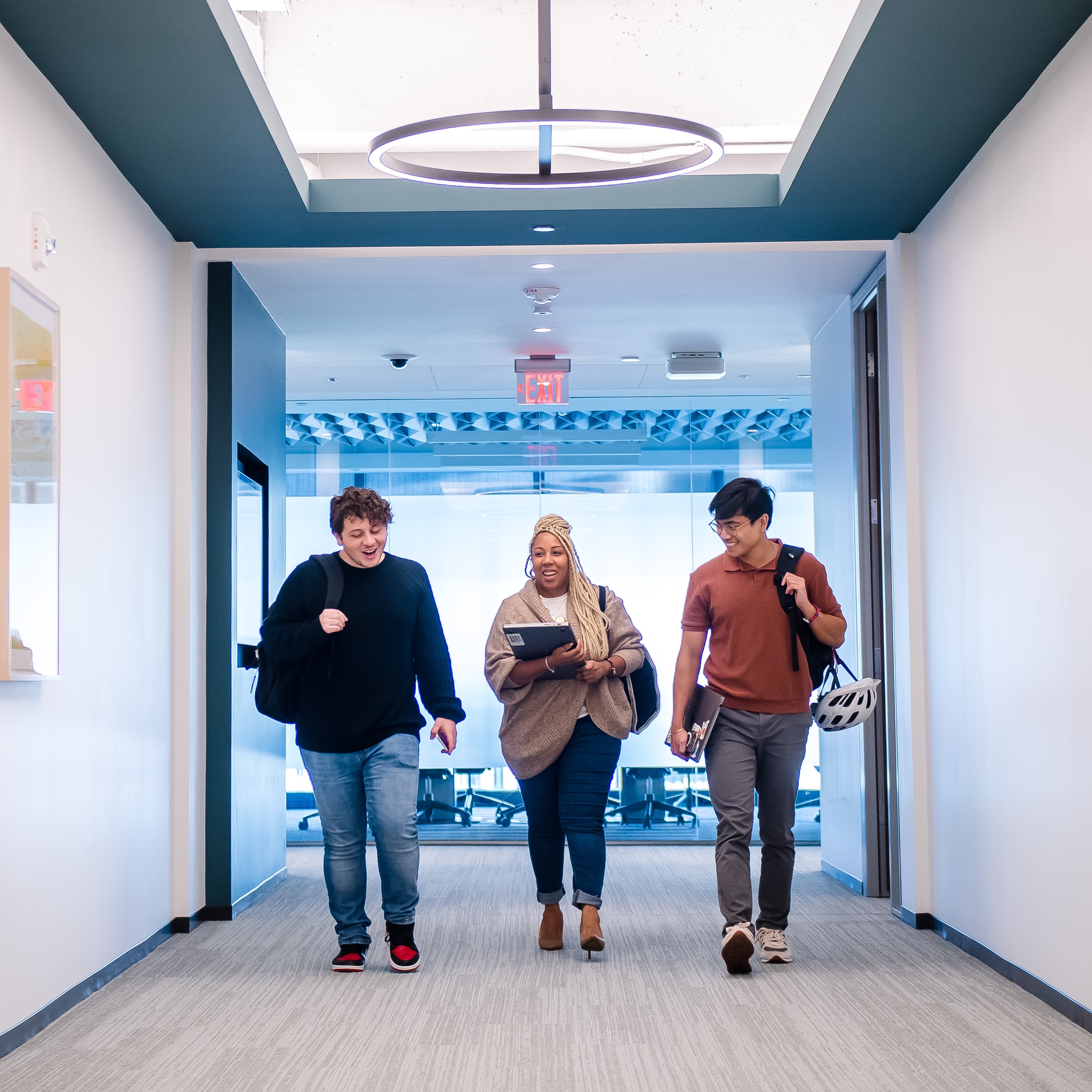 Three Capital One associates walk down a hallway