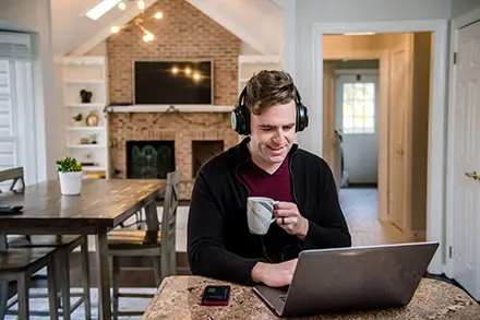 man working from laptop at home