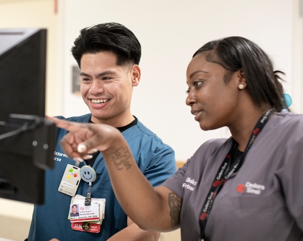 Female nurse demonstrating something on screen