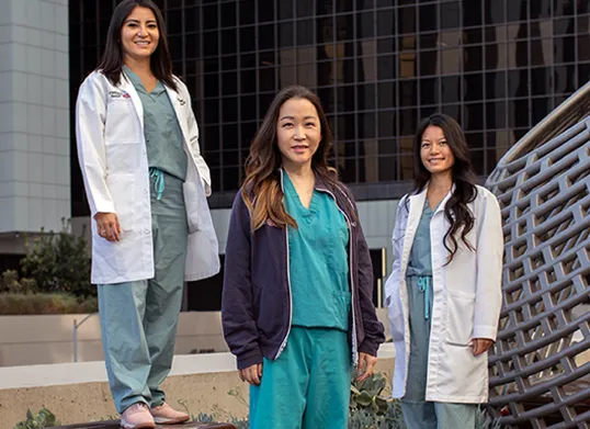 3 female healthcare providers posing