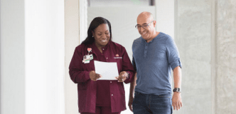 A nurse showing a document to a patient