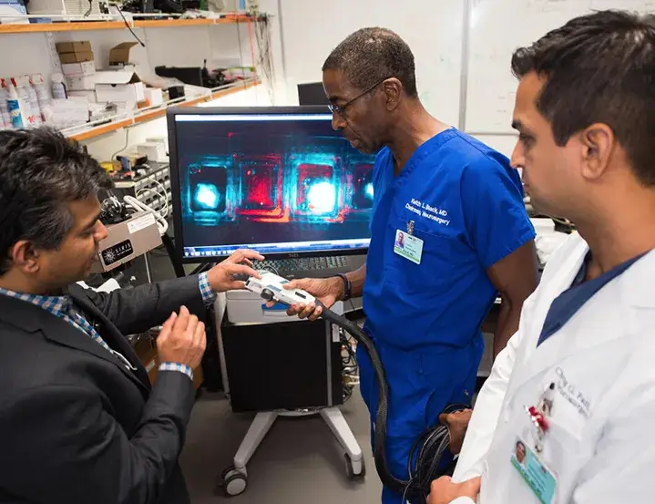 A couple of medical professionals looking at a medical device