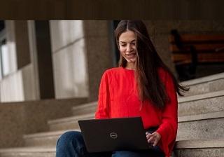 woman on steps on laptop