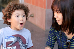 Woman and young boy, playing