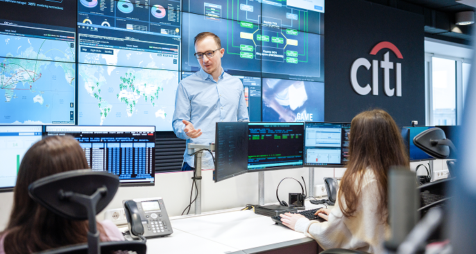 Colleagues speaking while at desks