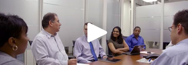 A still from a video showing an office meeting at ADT.