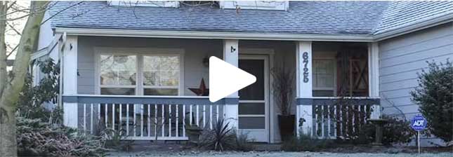 A still from a video showing the front porch of a house