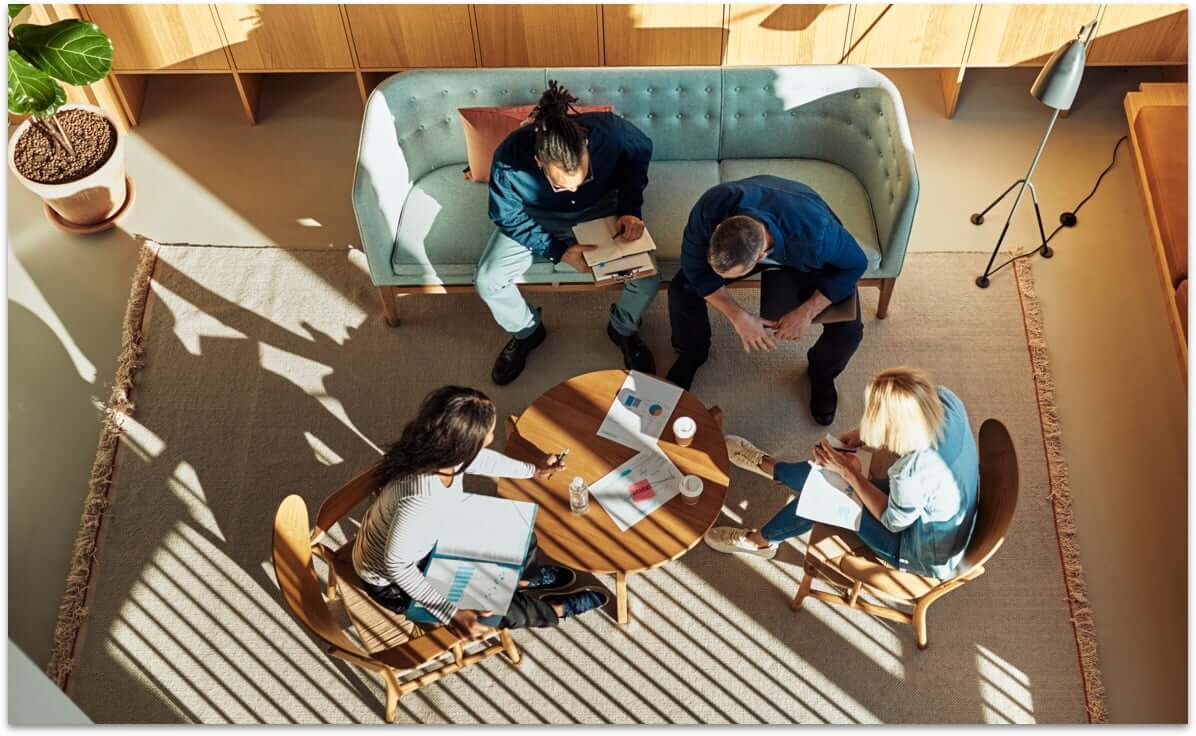 Four people meeting in a employee lounge