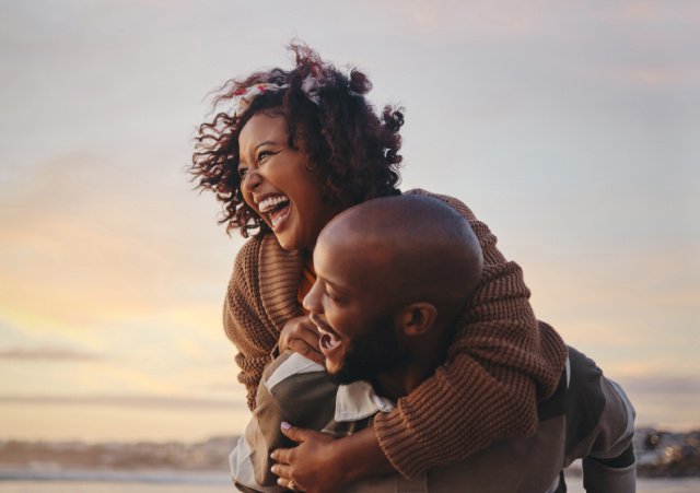 Man holding woman on his back