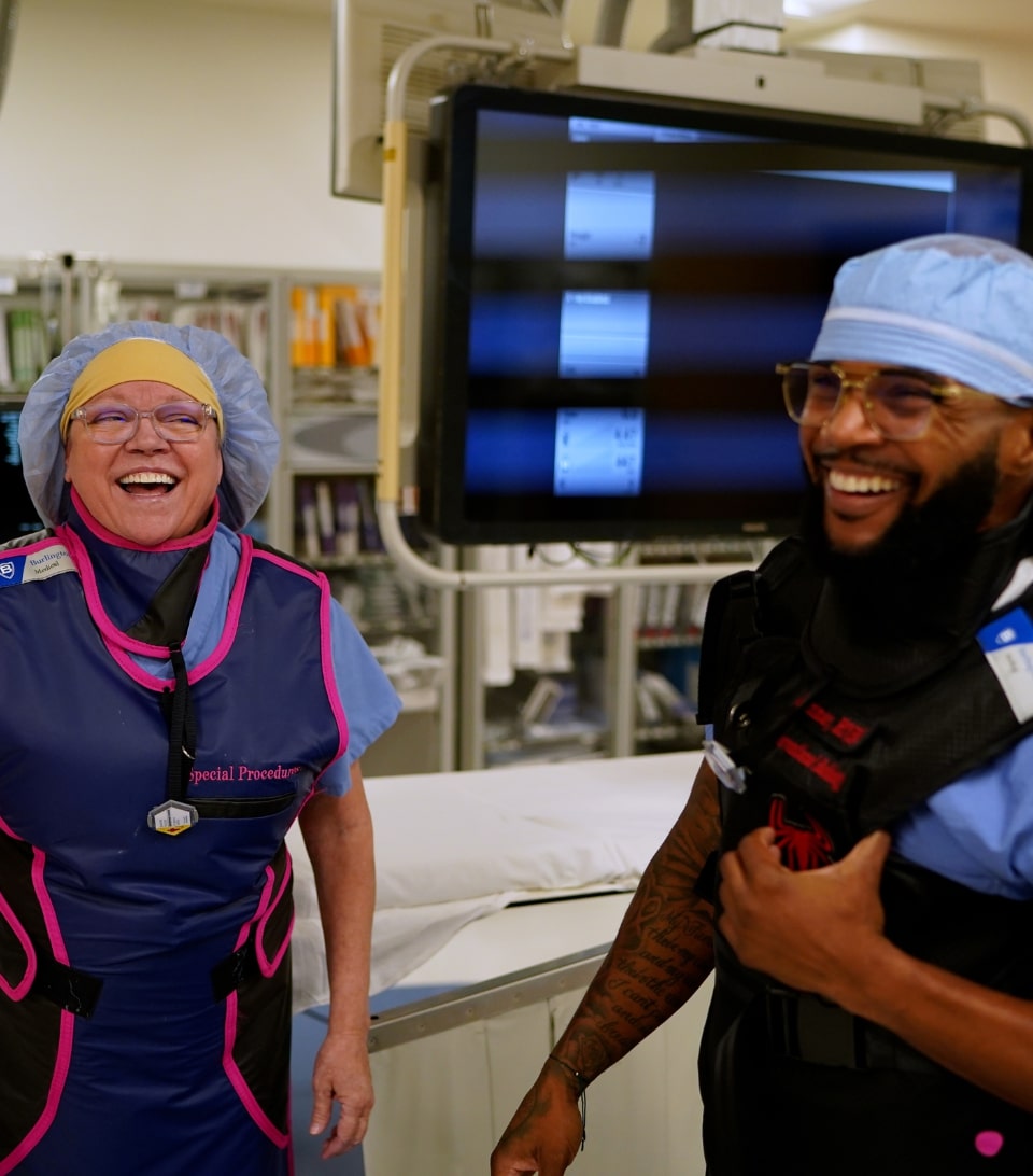 People wearing scrubs, smiling for the camera