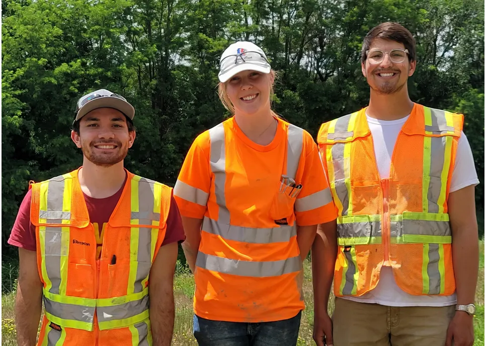 Three employees posing towards camera
