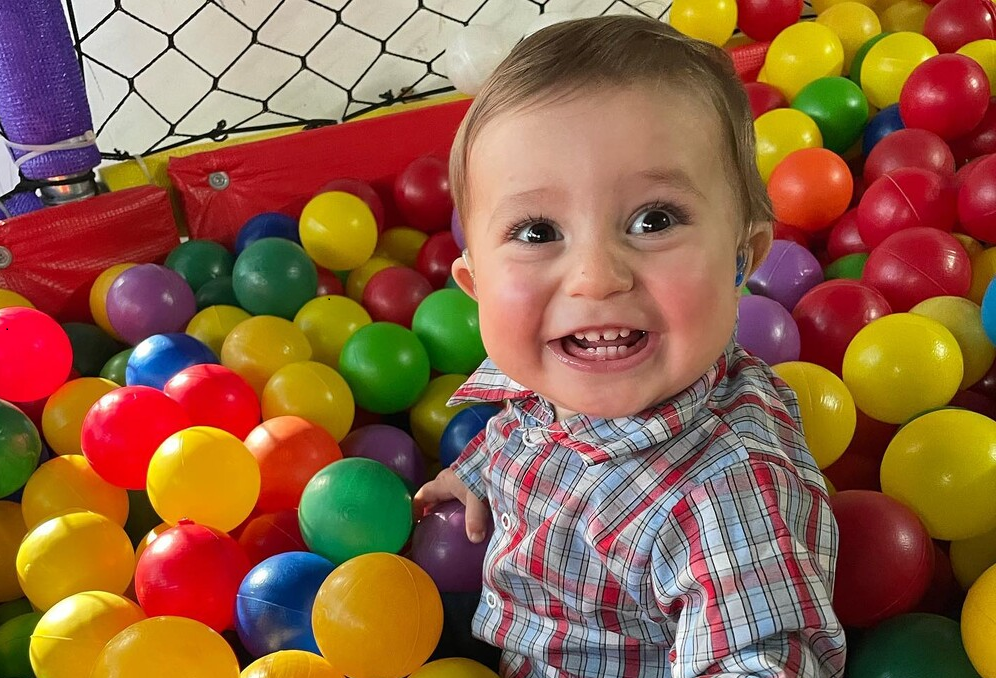 Camila's one-year-old son, Cooper, sits in a ball pit.