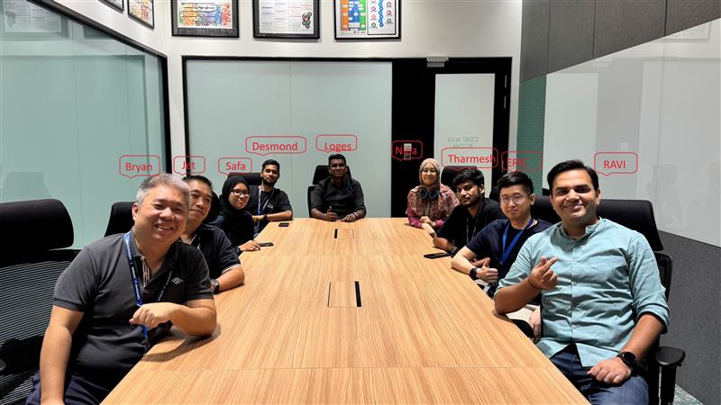 Desmond with his team in conference room
