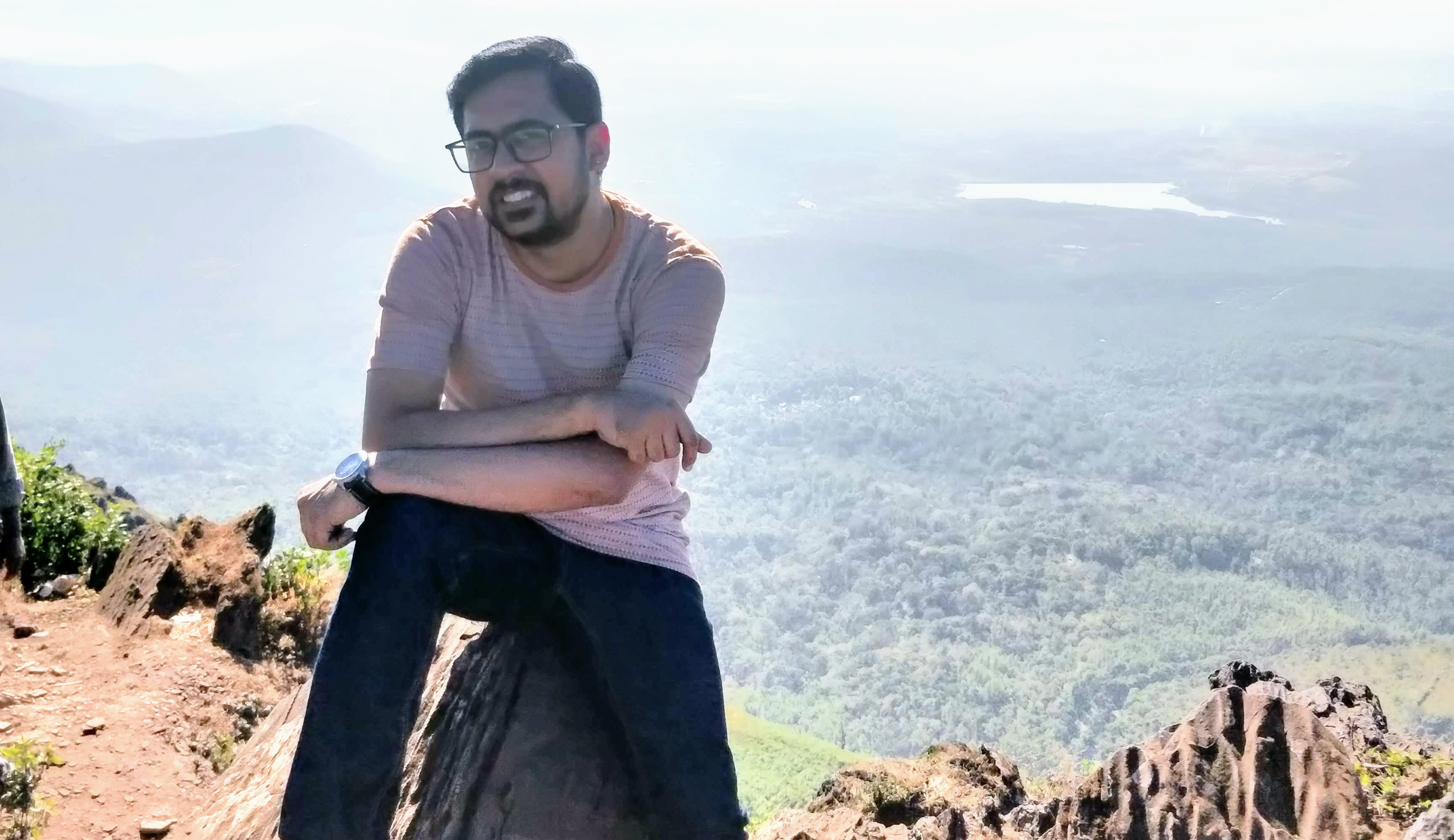 Sushil sits on a mountain.