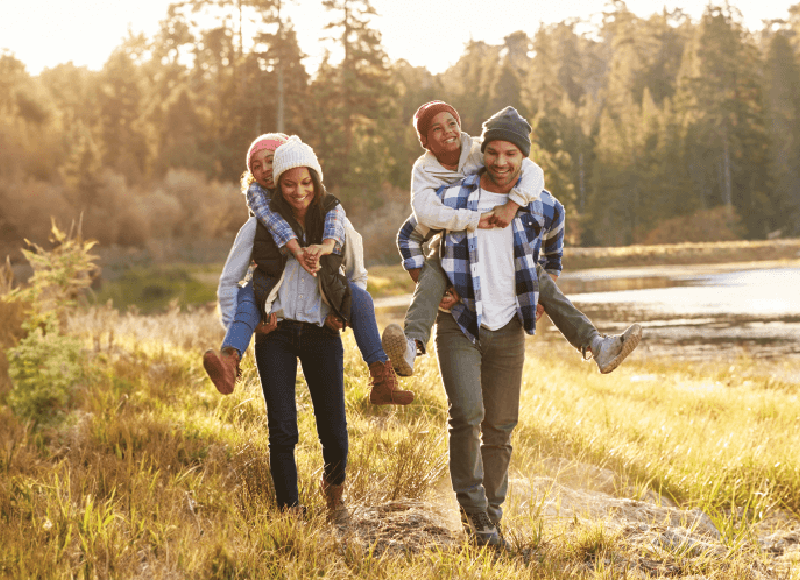 Family on a hike in the woods at sunset