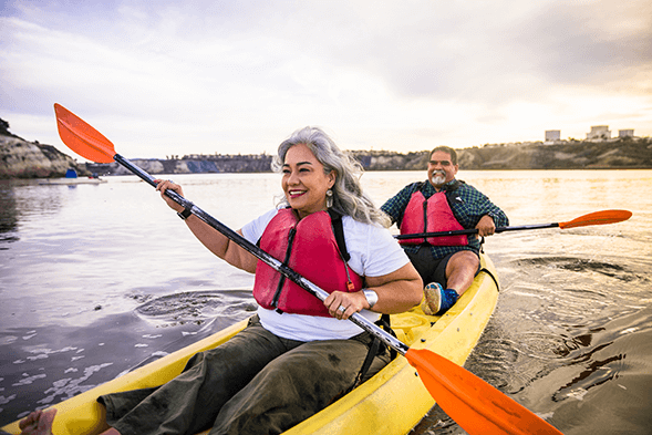 Retirement-age couple, paddling in a kayak