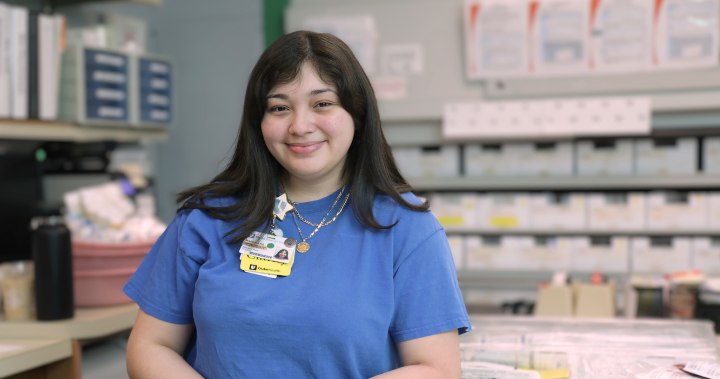 team member magdalena sanchez smiling in front of pharmacy counter