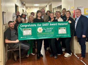 group photo of Havasu Regional Medical Center staff with DAISY Award banner