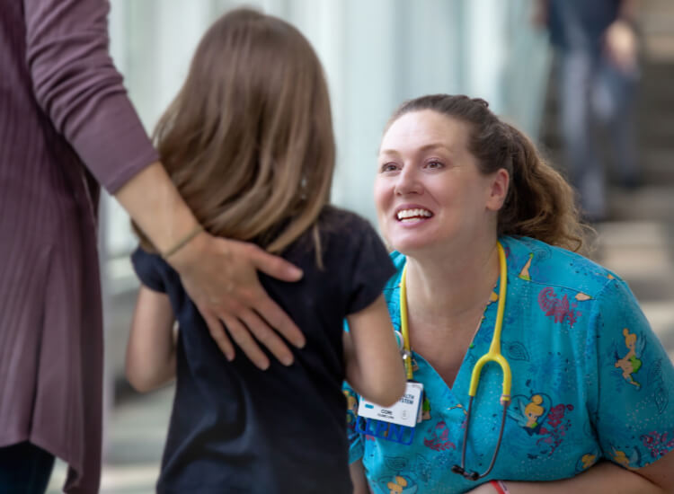portrait of nurse smiling toward patient