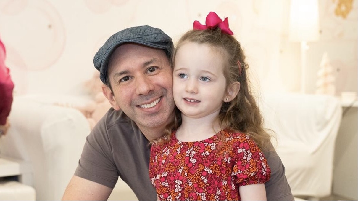 Father and daughter smiling