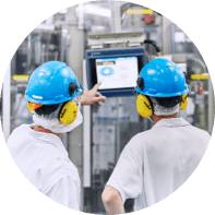 Two men pointing at a machine