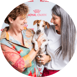 two women holding a dog