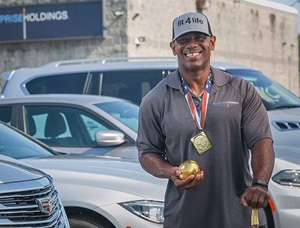 Frederick wearing a medal and holding a shotput