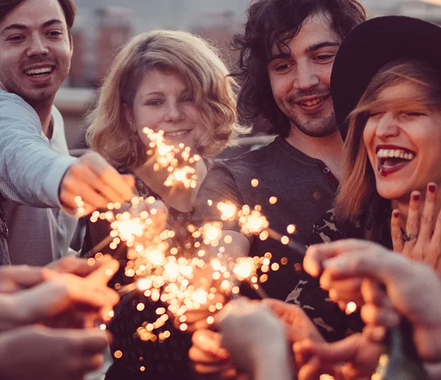 Group of people celebrating with sparklers