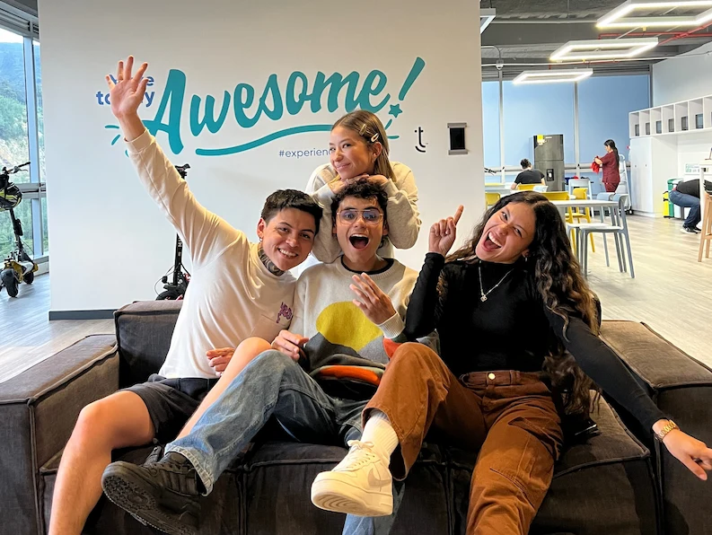 Four TTEC team members posing for a picture happily.