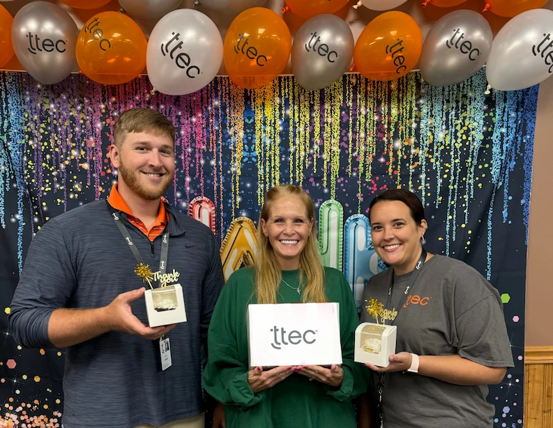TTEC team holding tokens of appreciation.