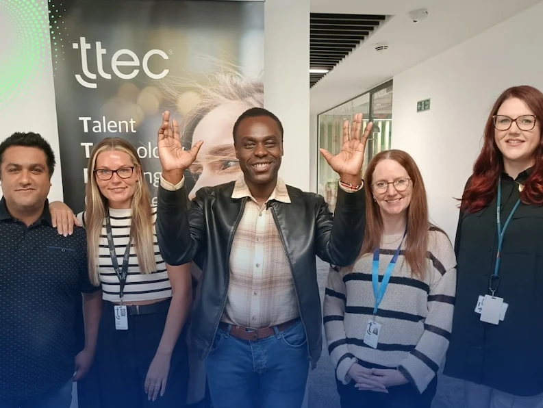 Five diverse TTEC team members smiling.