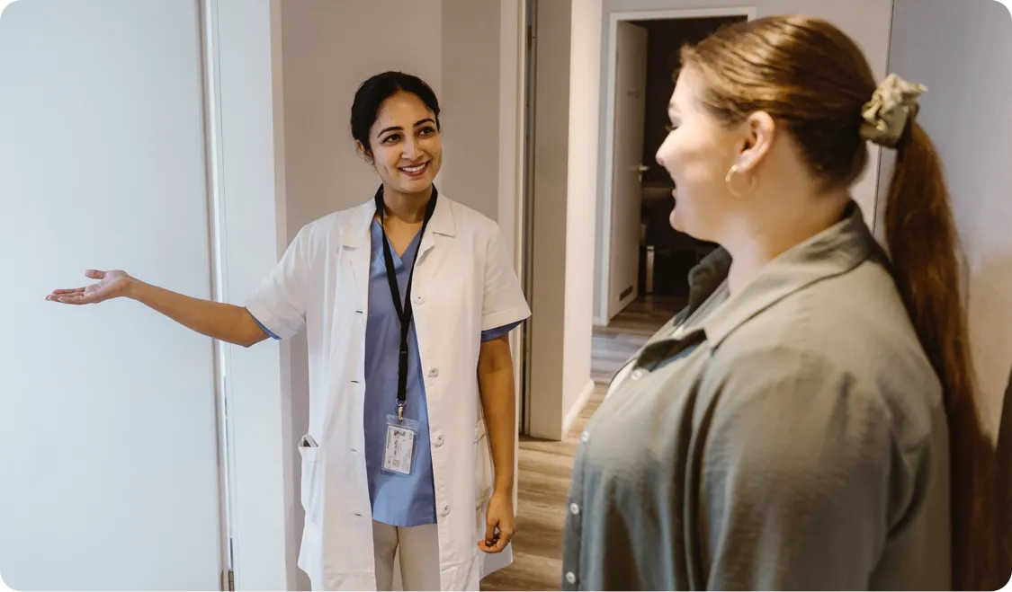 Nurse showing a patient to her appointment room