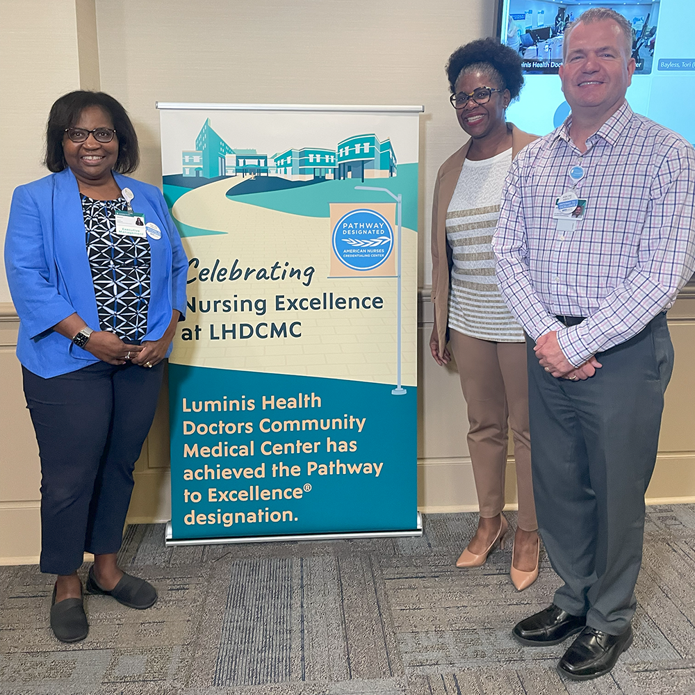 woman standing in front of LHDCMC sign