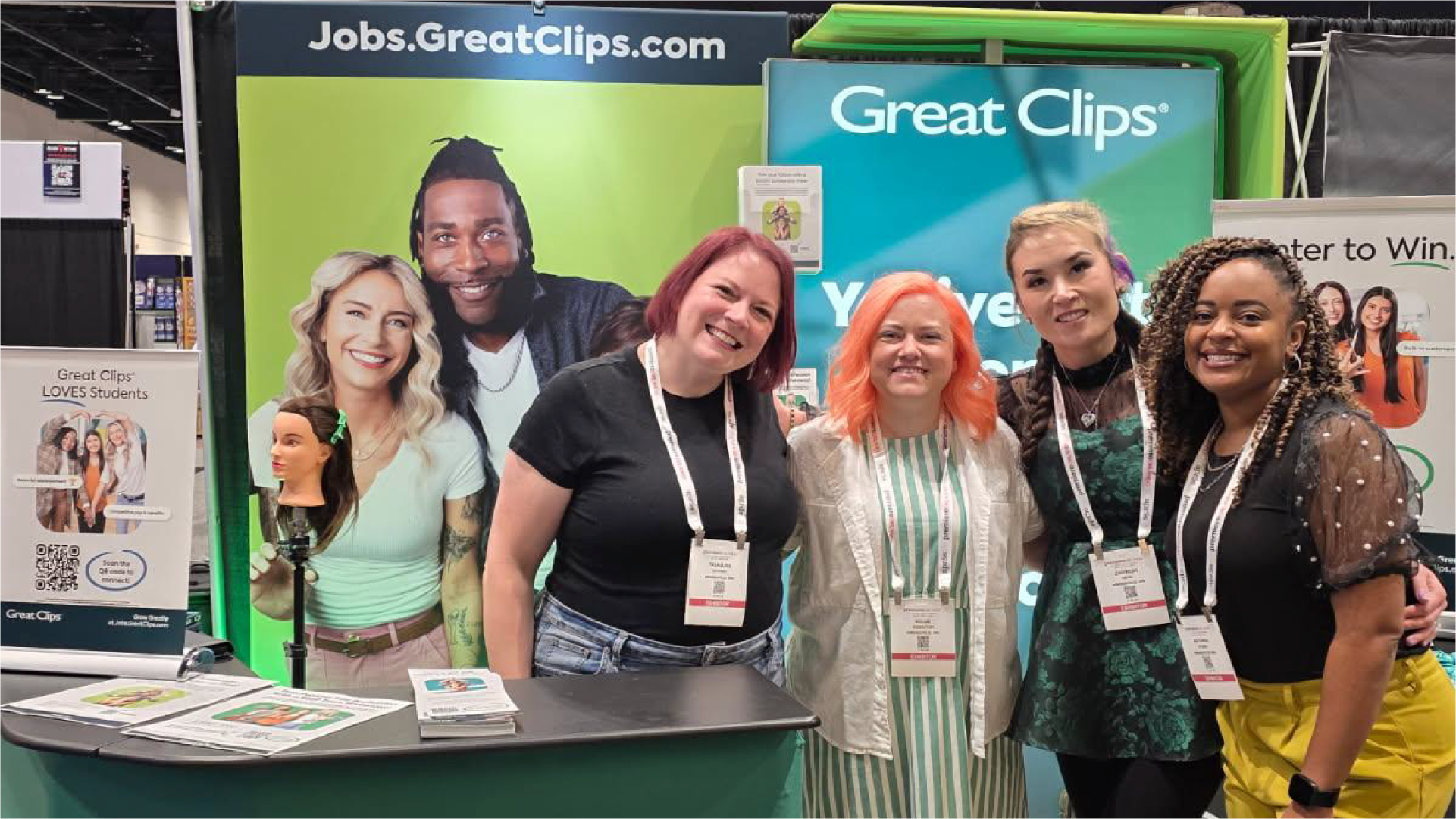 Smiling group of women standing in Great Clips booth at Premiere Orlando hair show
