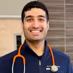 Dr. Fazal Rehman smiling for a picture with a stethoscope around the back of his neck